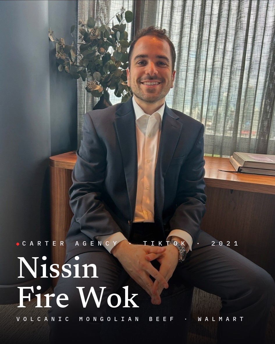 Josh Popkin, founder of Carter Agency, seated in a suit, with the title Nissin Fire Wok